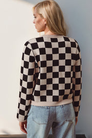 Checkerboard knit cardigan in black and beige acrylic with crew neck and long sleeves.