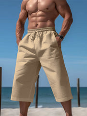 Relaxed fit cropped sweatpants in earthy yellow with drawstring waist and pockets.