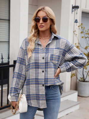Oversized blue and white plaid shirt jacket with button front and chest pocket.