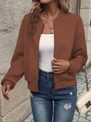 Caramel geometric quilted bomber jacket with a round neckline and zipper closure.
