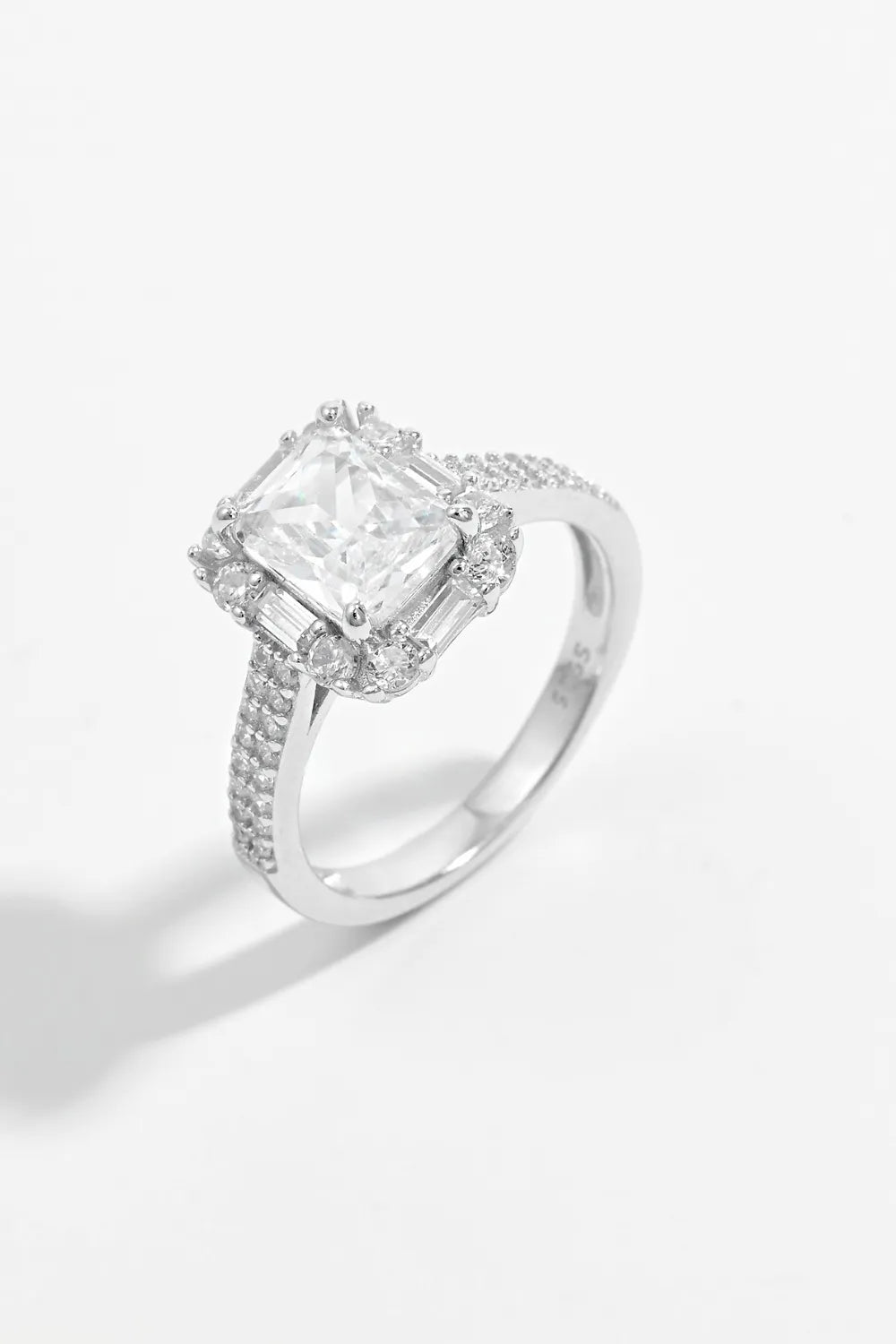 Silver radiant emerald cut halo ring with pave band and baguette accents