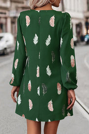 Green feather print mini dress with long sleeves and cutout neckline.