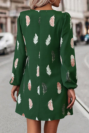 Green feather print mini dress with long sleeves and cutout neckline.