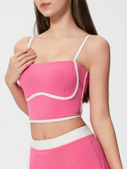 Fuchsia pink crop top with white piping and sculpted bust detail.