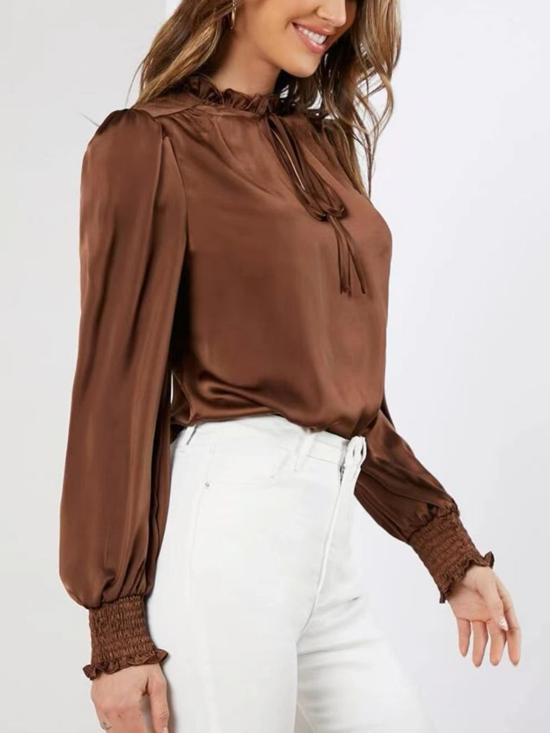 Brown satin blouse with tie-neck, ruffled collar, and shirred cuffs.