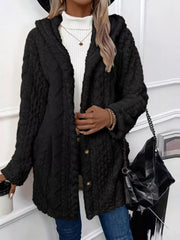 Black hooded trench coat with button detail and textured fabric.