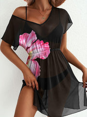 Black sheer mini dress with pink floral print, V-neck, short sleeves, and side slit.
