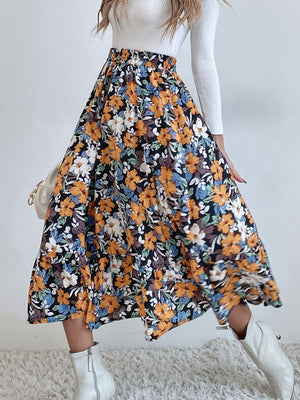 Tiered midi skirt with a black floral print and orange, white, and blue flowers.