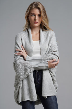 Gray knit batwing cardigan with drape front and textured sleeves.