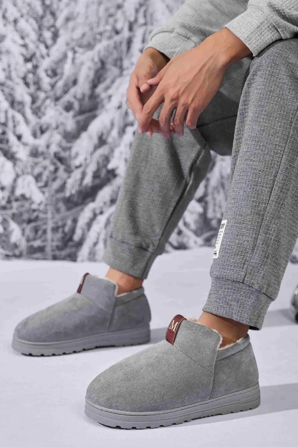 Gray suede shearling-lined house booties with a pull tab detail.