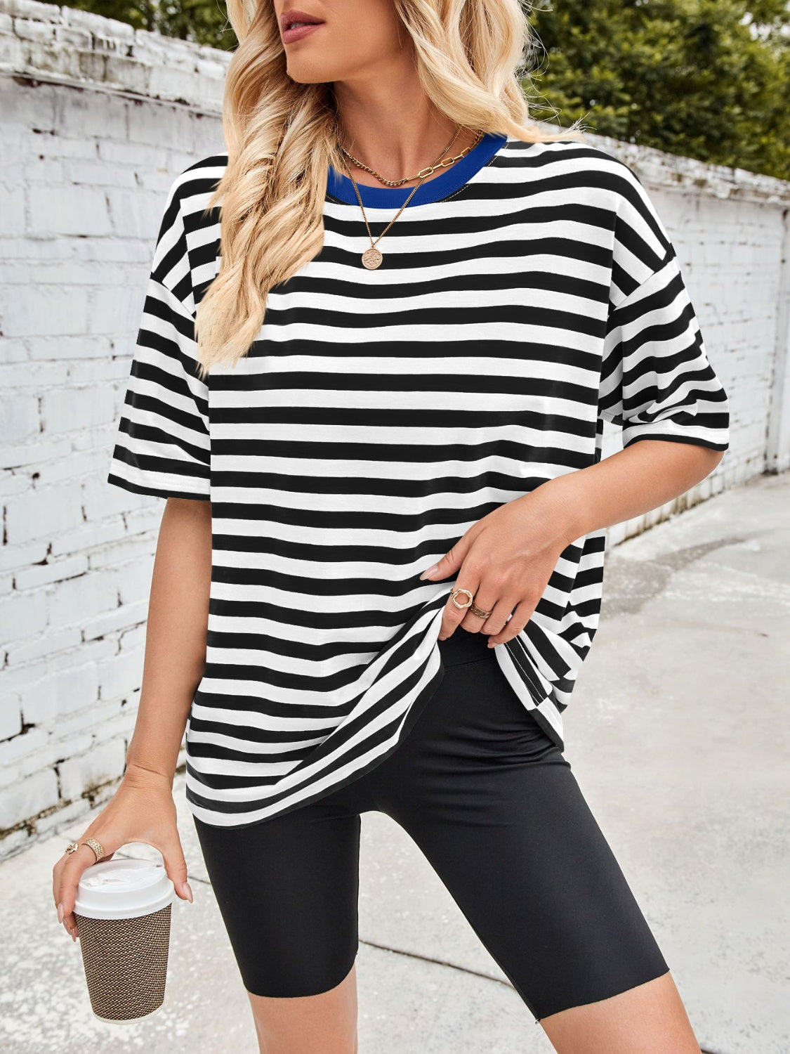 Relaxed fit t-shirt with black and white stripes and a blue contrast neck.