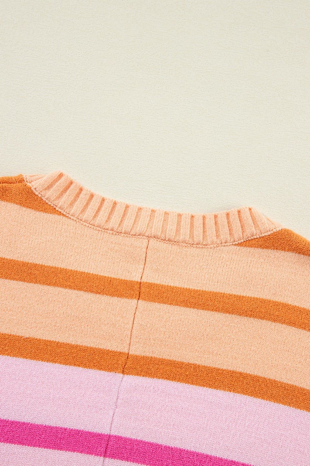 Ombre stripe knit sweater with ribbed neckline in sherbet and pink tones.