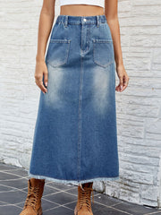 Faded blue denim midi skirt with frayed hem and front pockets.
