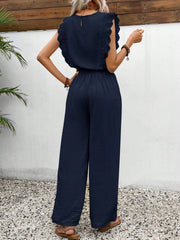 Dark blue textured jumpsuit with ruffle sleeves and wide legs