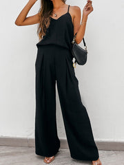 Black cami and pleated palazzo pants set with a V-neck camisole and wide-leg trousers.