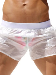 White sheer swim shorts with pocket detail and floral print briefs underneath
