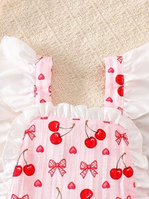 Pink baby dress with cherry print, ruffle trim, and white flutter sleeves.