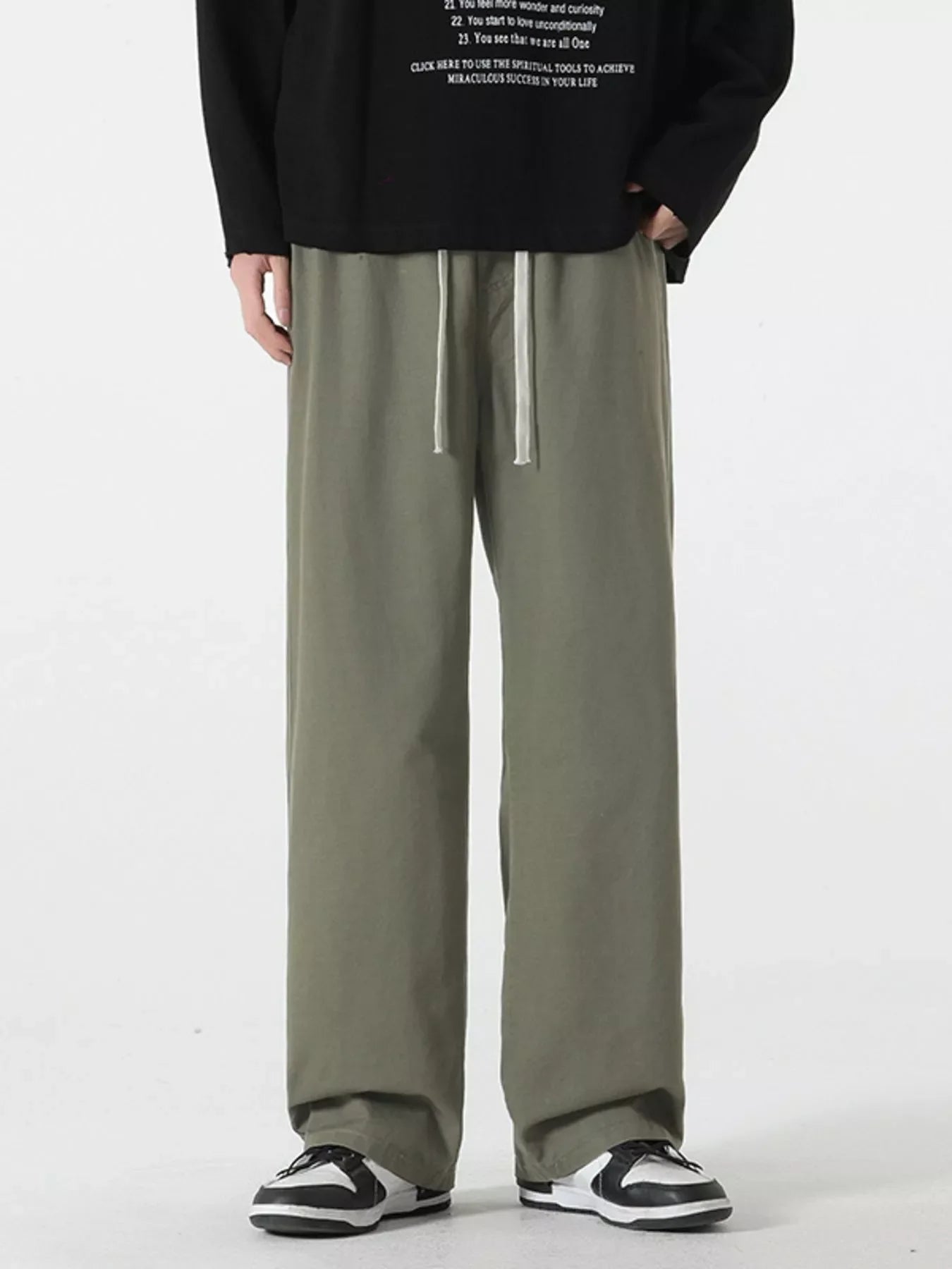 Relaxed fit drawstring pants in Military Green with a white drawstring detail.
