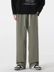 Relaxed fit drawstring pants in Military Green with a white drawstring detail.