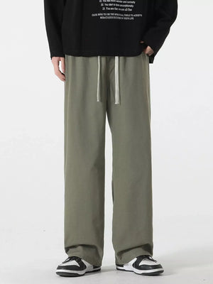 Relaxed fit drawstring pants in Military Green with a white drawstring detail.