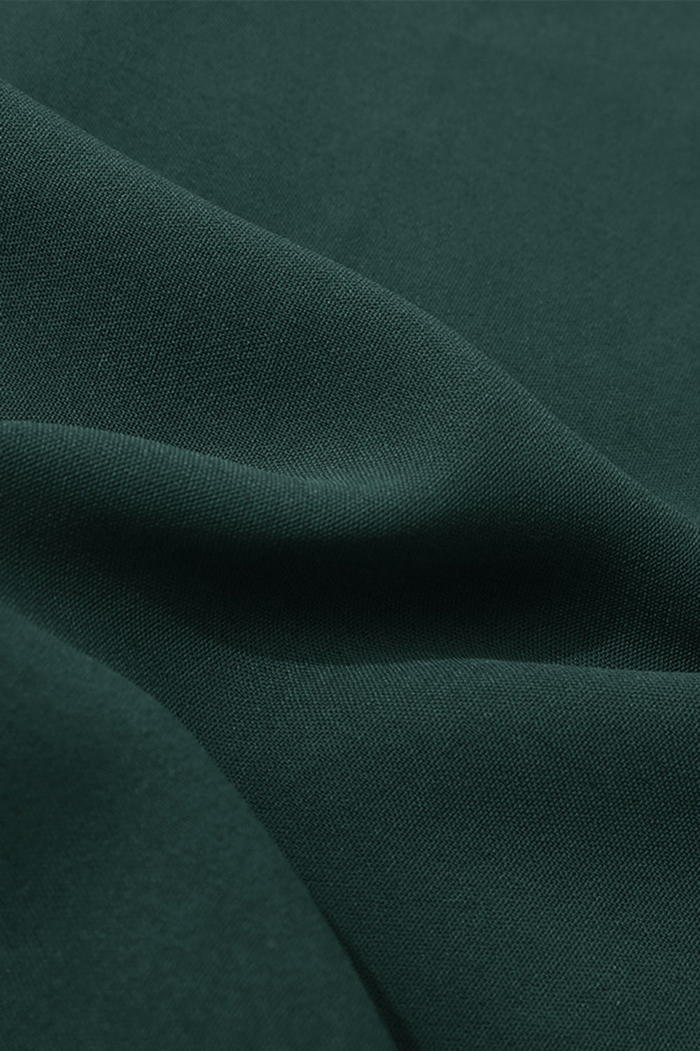 Dark green polyester midi dress fabric detail with soft folds.
