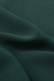 Dark green polyester midi dress fabric detail with soft folds.