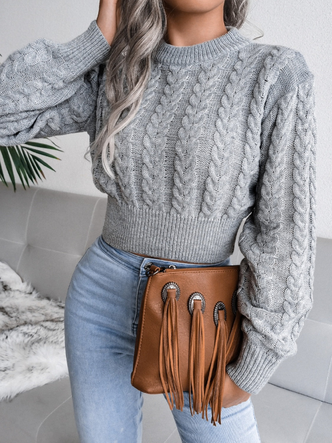 Dark gray cable knit cropped mock neck sweater with balloon sleeves.