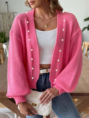 Fuchsia pink bubble sleeve cardigan with pearl buttons, open front, and ribbed cuffs.