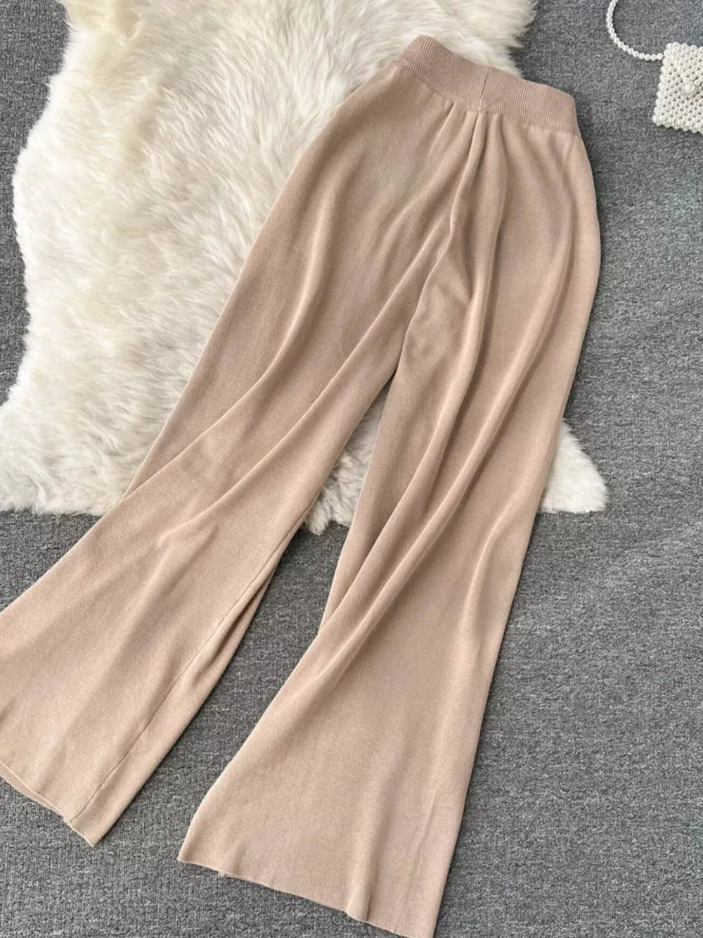 Khaki knit wide leg pants with a tied waist and elastic waistband.