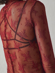 Deep red floral lace illusion mock neck blouse with sheer long sleeves.