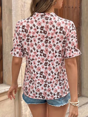 Floral tie-neck shirt with ruffle sleeves in pink and brown floral print.