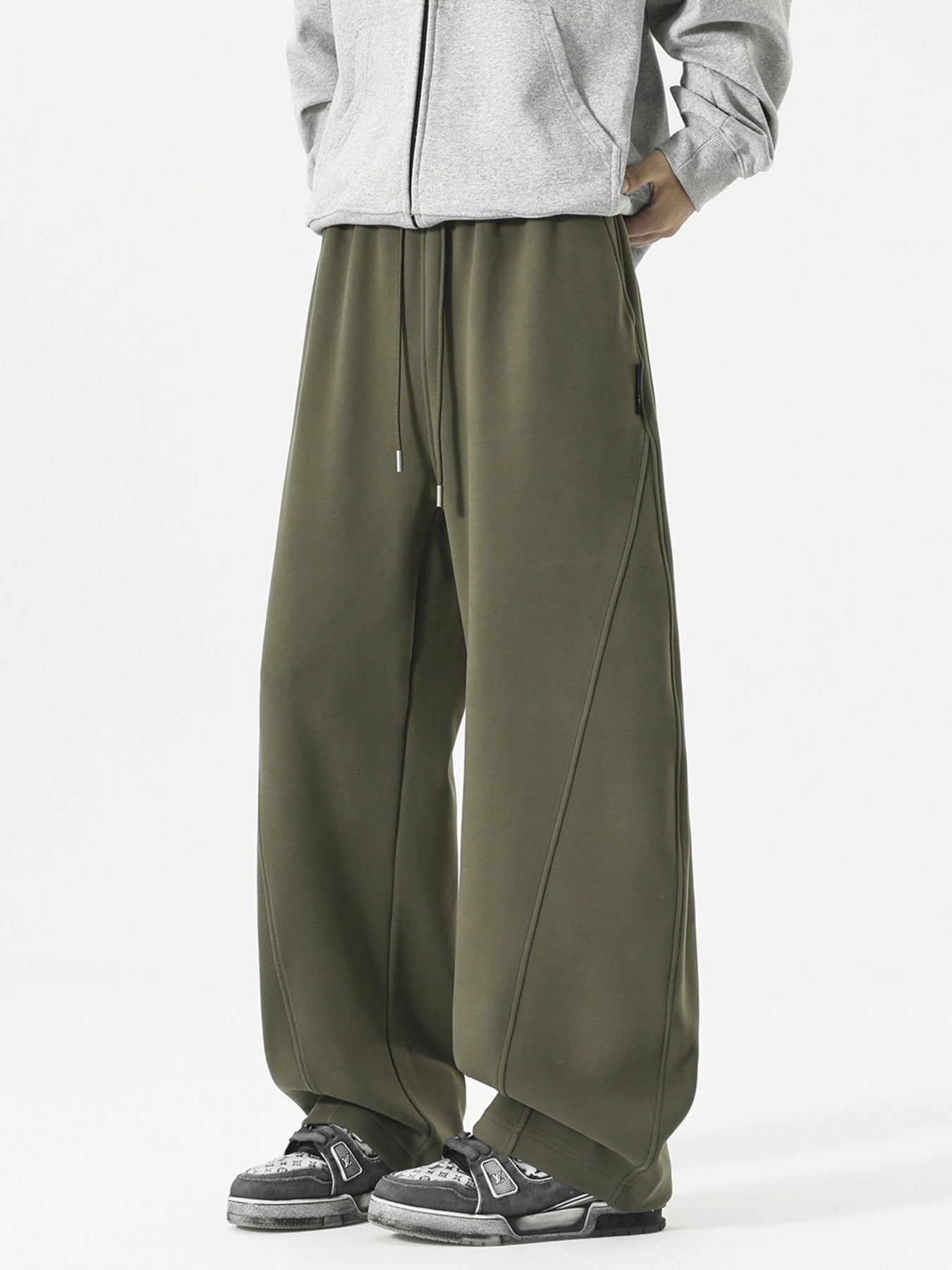 Men's relaxed fit army green sweatpants with drawstring and diagonal seam detail.