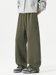 Men's relaxed fit army green sweatpants with drawstring and diagonal seam detail.