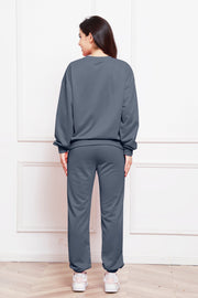 Relaxed fit dark gray loungewear set with crewneck sweatshirt and cuffed sweatpants.