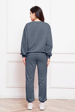 Relaxed fit dark gray loungewear set with crewneck sweatshirt and cuffed sweatpants.