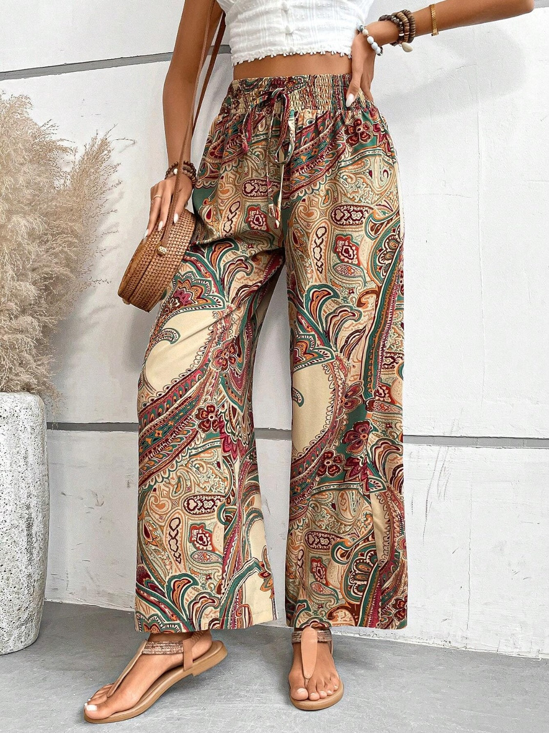 Paisley palazzo trousers with drawstring waist in multicolor, featuring a relaxed fit and wide leg.