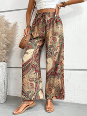 Paisley palazzo trousers with drawstring waist in multicolor, featuring a relaxed fit and wide leg.