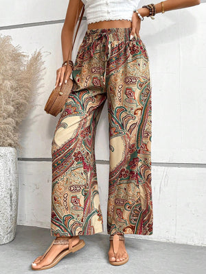 Paisley palazzo trousers with drawstring waist in multicolor, featuring a relaxed fit and wide leg.