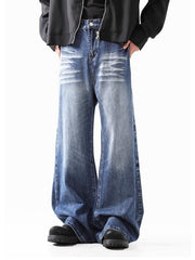 Relaxed fit washed denim jeans in blue with distressed details and wide leg.