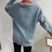 Teal acrylic sweater with scalloped trim and ribbed cuffs.
