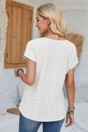 White perforated eyelet cuffed tee with short sleeves and a relaxed fit.