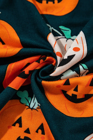 Pajama set with orange jack-o'-lanterns on a dark teal background.