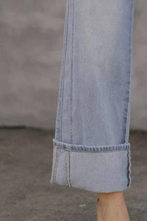 Light wash wide-leg denim jeans with contrast cuffs and visible stitching.