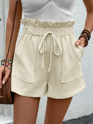 Cream textured paperbag shorts with tie waist and front pockets