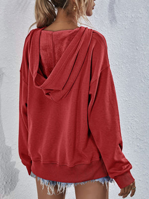 Boxy hooded sweatshirt in Brick Red with plush lining and split hem detail.