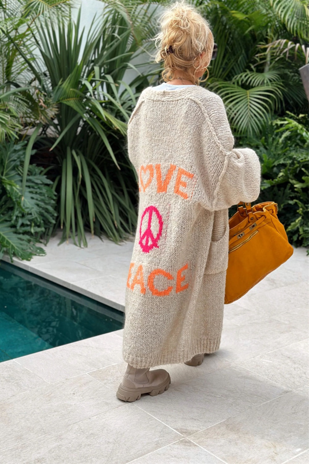 Long knit cardigan in beige with orange and pink peace and love graphic on back