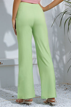 Neon green split-hem tailored trousers with a flared leg.