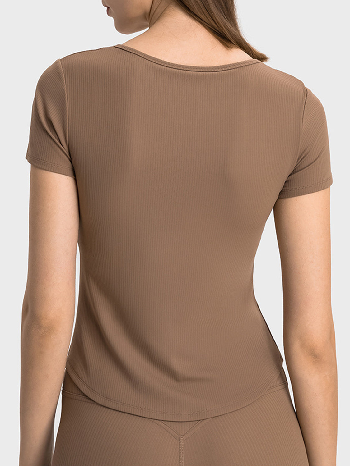 Brown ribbed active top with short sleeves and a notch neckline.