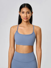 Strappy back active crop top in Dusty Blue with a scoop neckline.