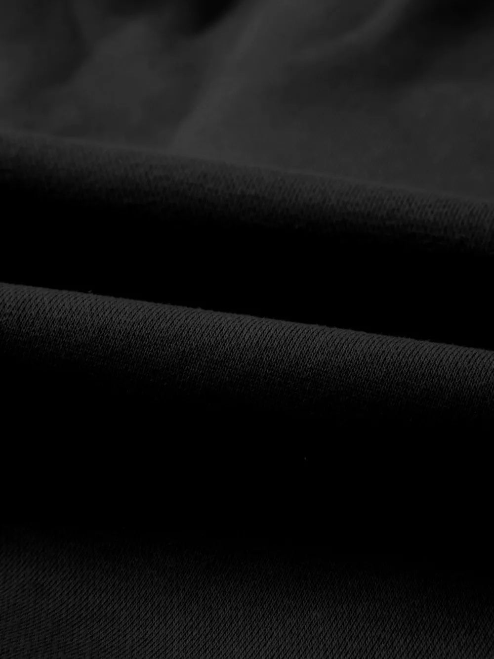 Black cotton joggers with a textured knit detail.